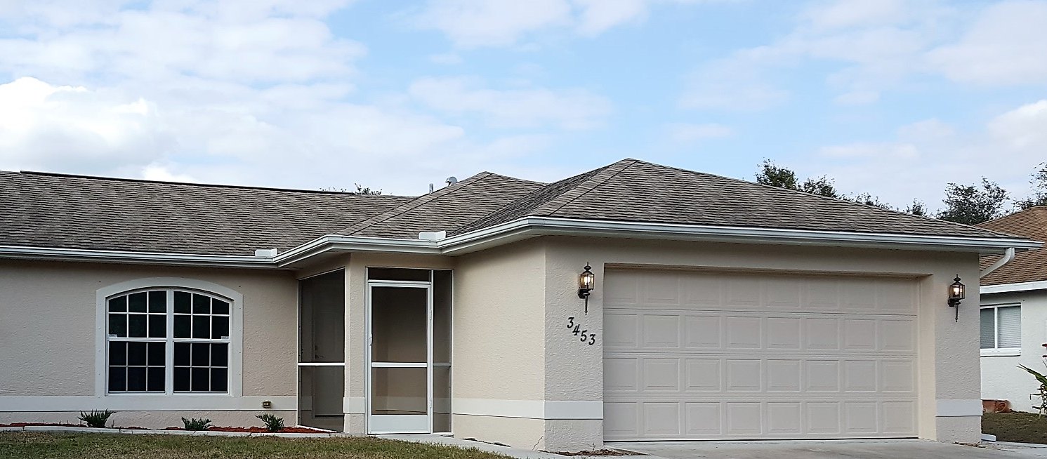 The same house front after a full exterior repaint